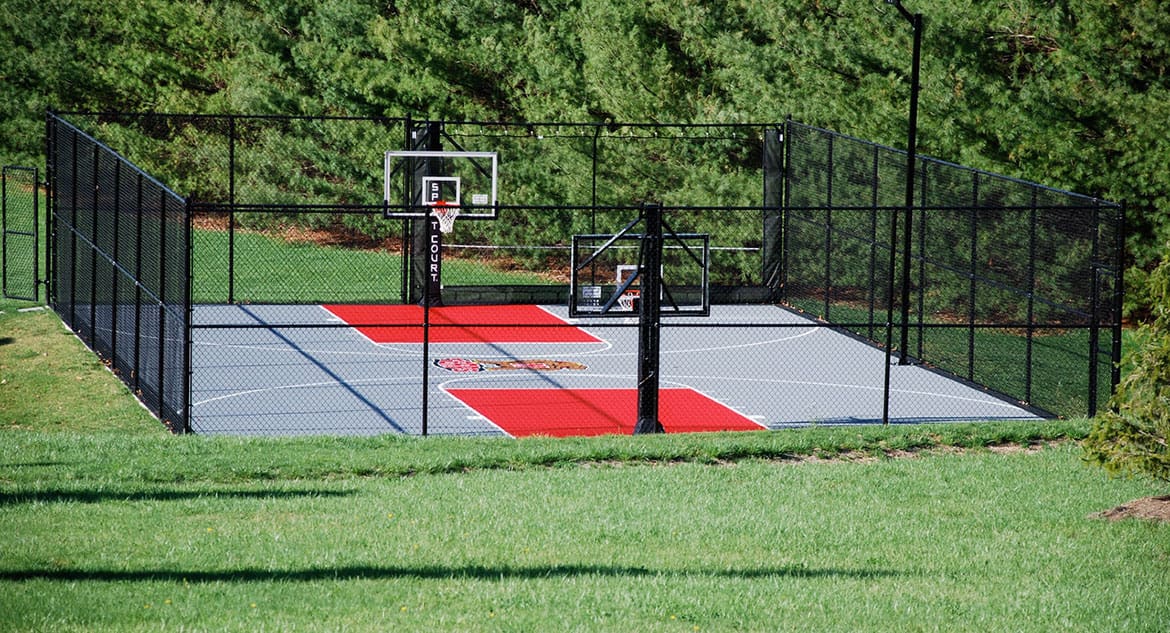 A basketball court with two red and black nets.