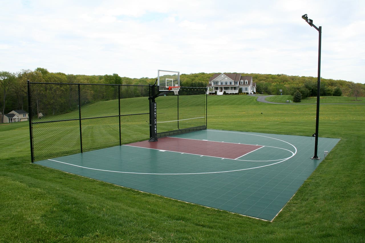 A basketball court with a net and a basket ball hoop.