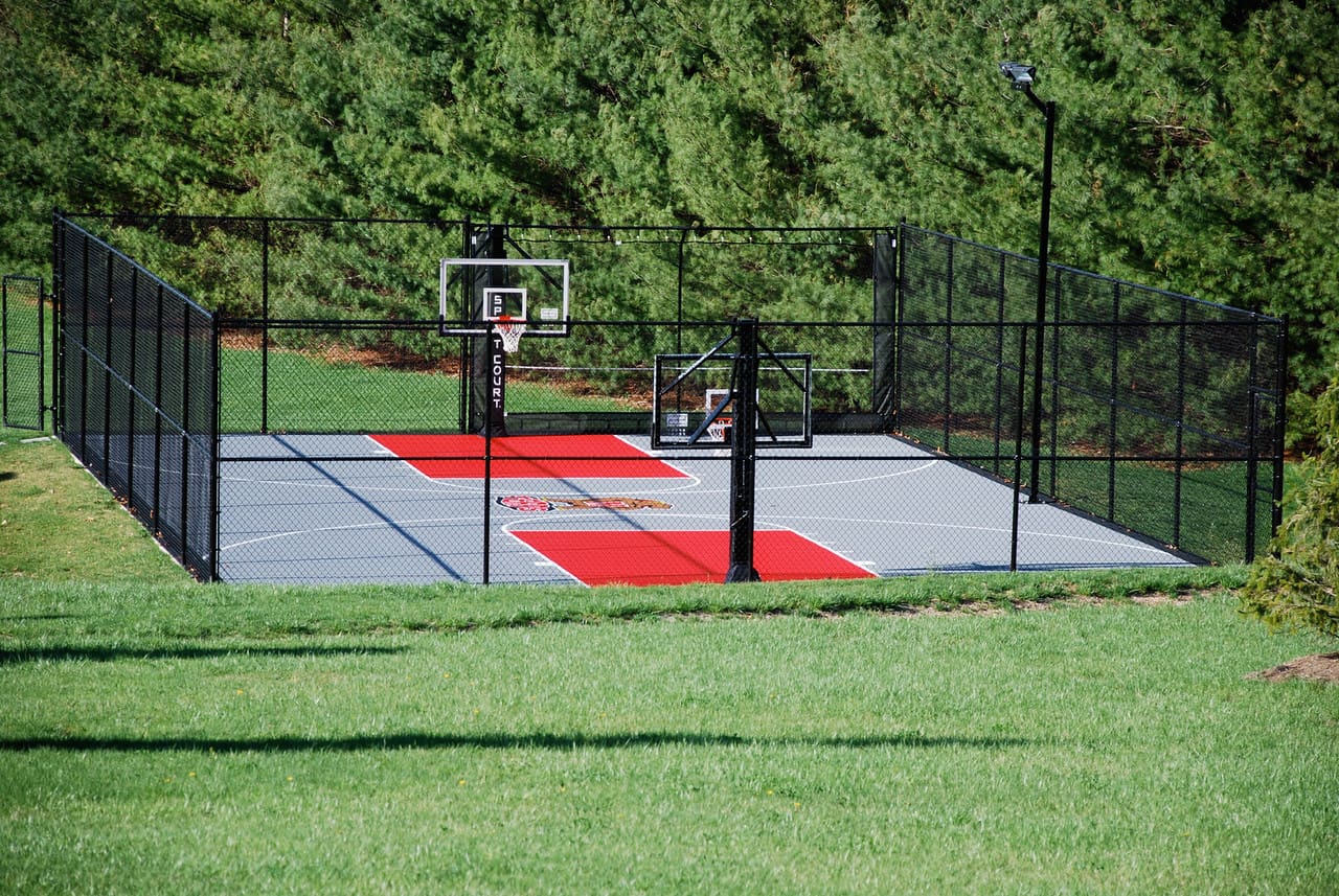 A basketball court with two hoops and a net.