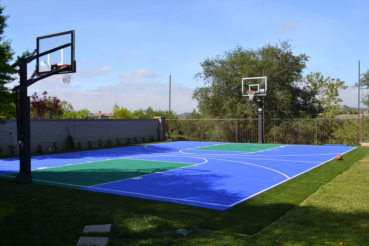 A basketball court with a green and blue surface.