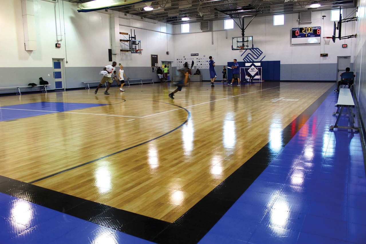 A group of people playing basketball on a court.