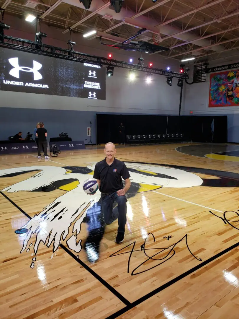 A man standing on top of a basketball court.