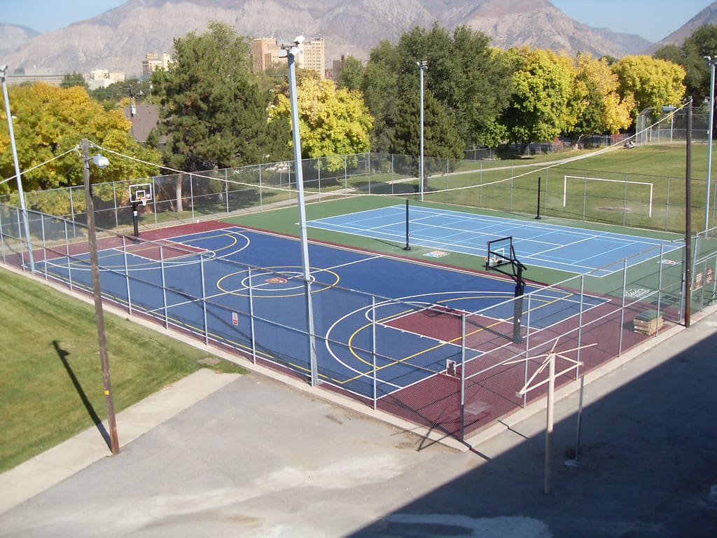 A basketball court with trees in the background