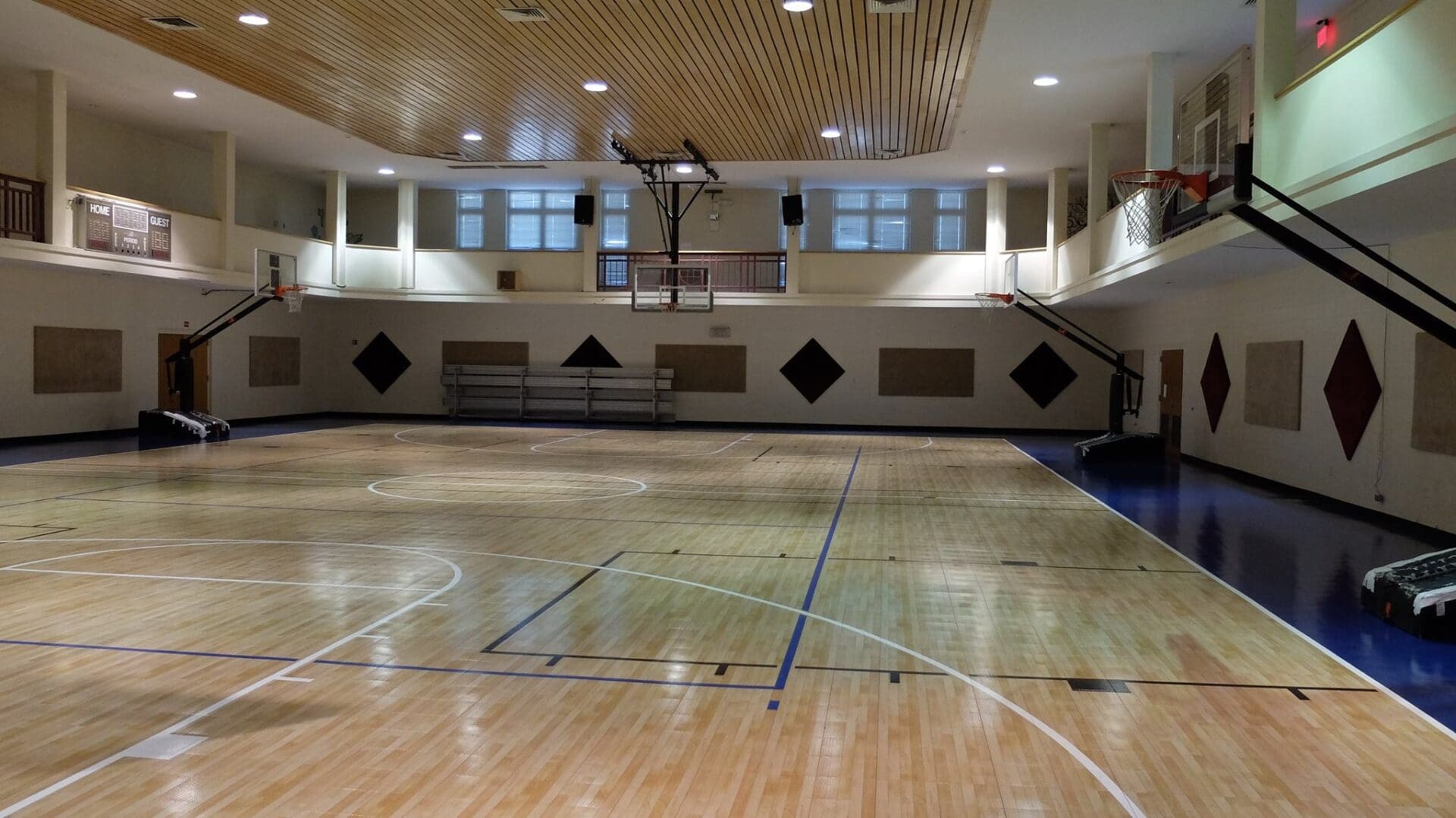 A gym with basketball court and bleachers.