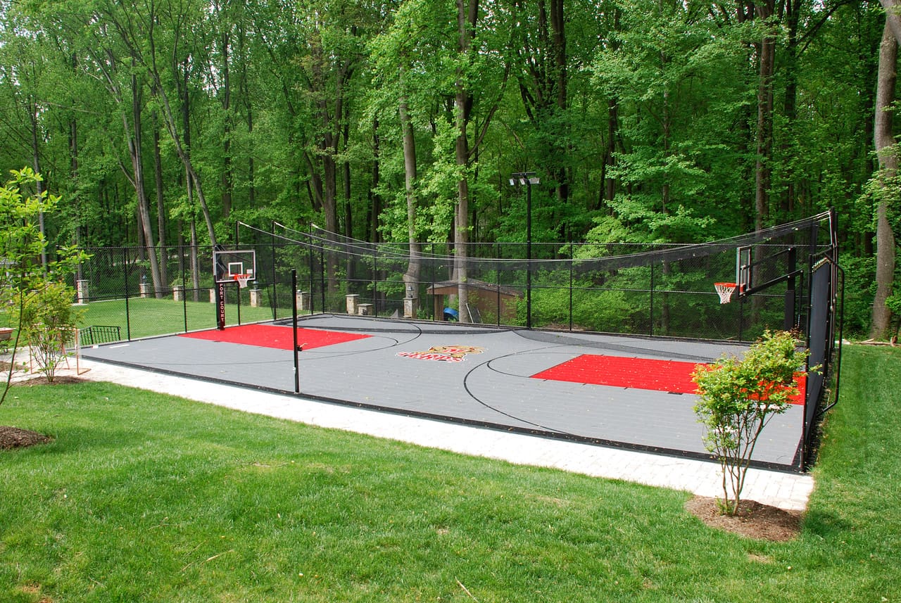 A basketball court with two red and white hoops.