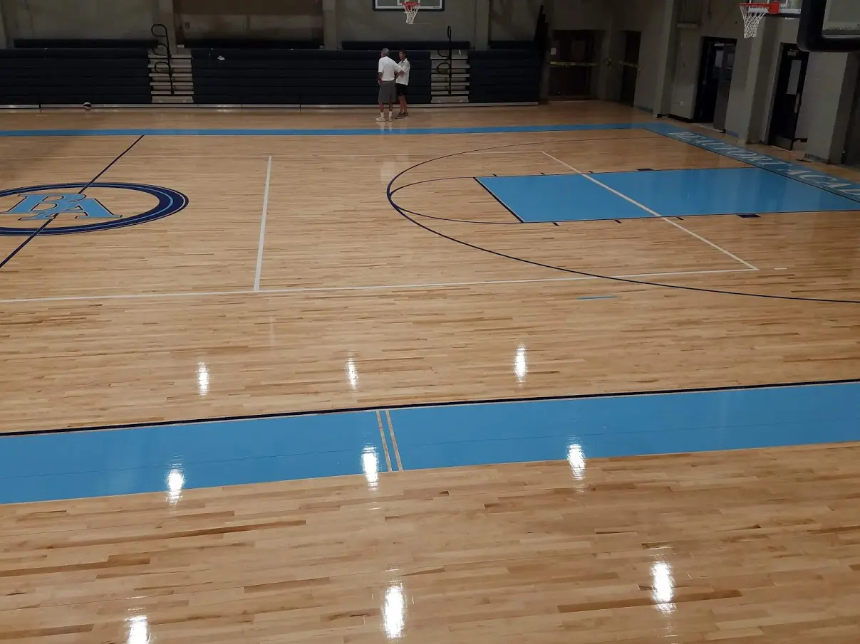 A basketball court with blue lines on the floor.