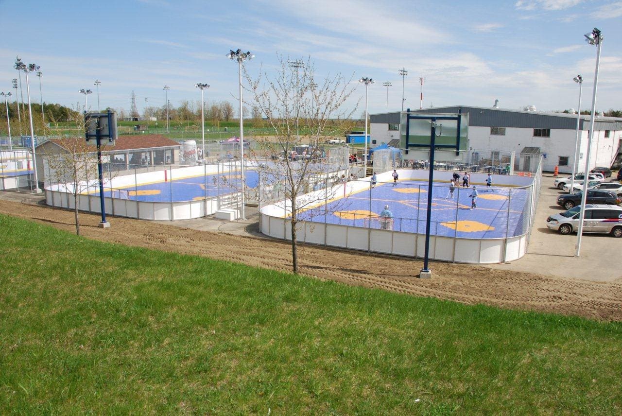 A field with many people playing basketball