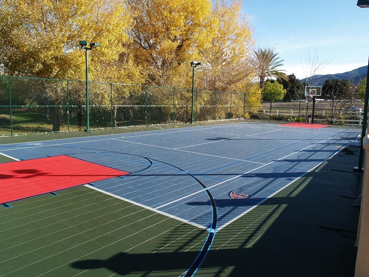 A tennis court with trees in the background.