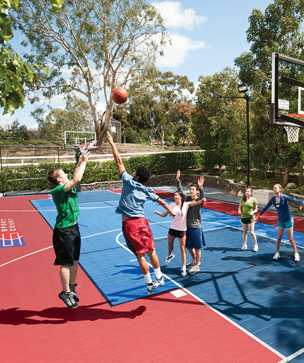 A group of kids playing basketball on a court.