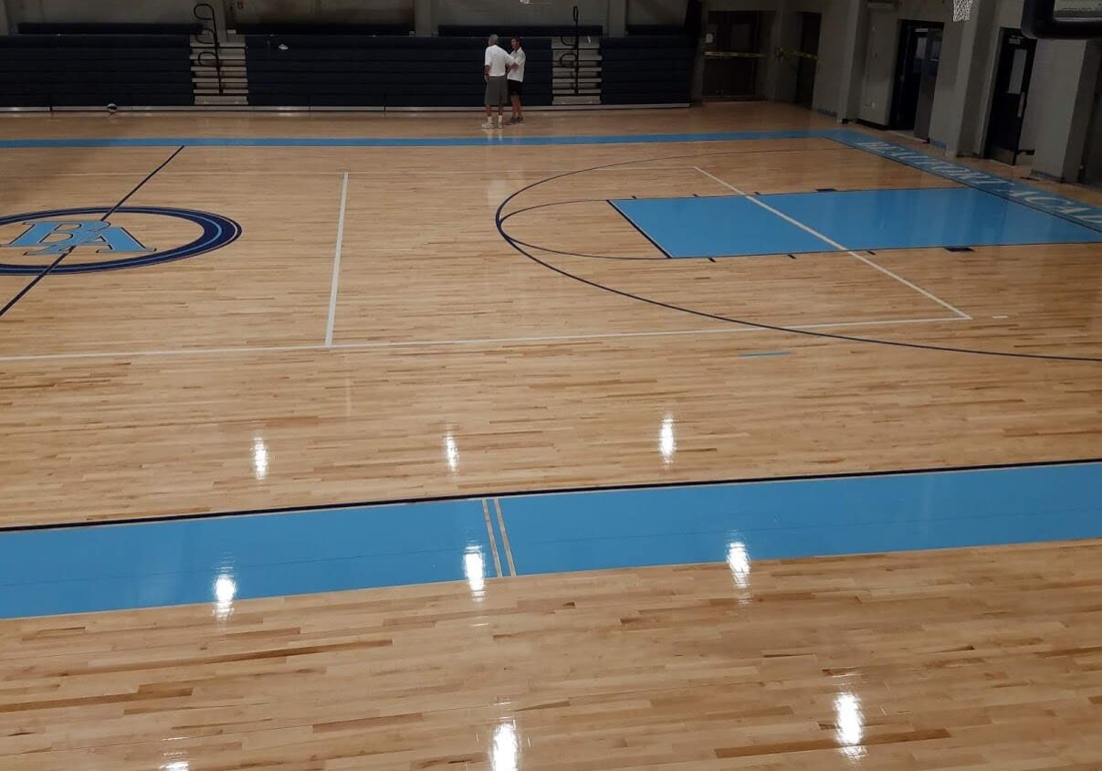 A basketball court with blue lines on the floor.