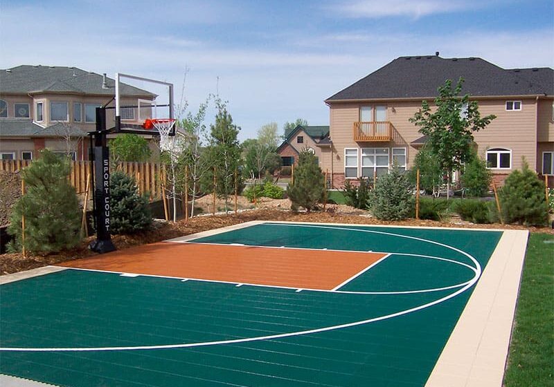 A basketball court in the middle of a yard.